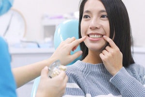 A dentist helping a patient.