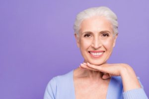 Smiling woman with dental implants in West Brookfield