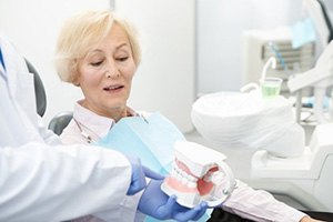 a patient being shown model teeth