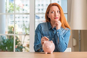 a woman saving money in a piggy bank